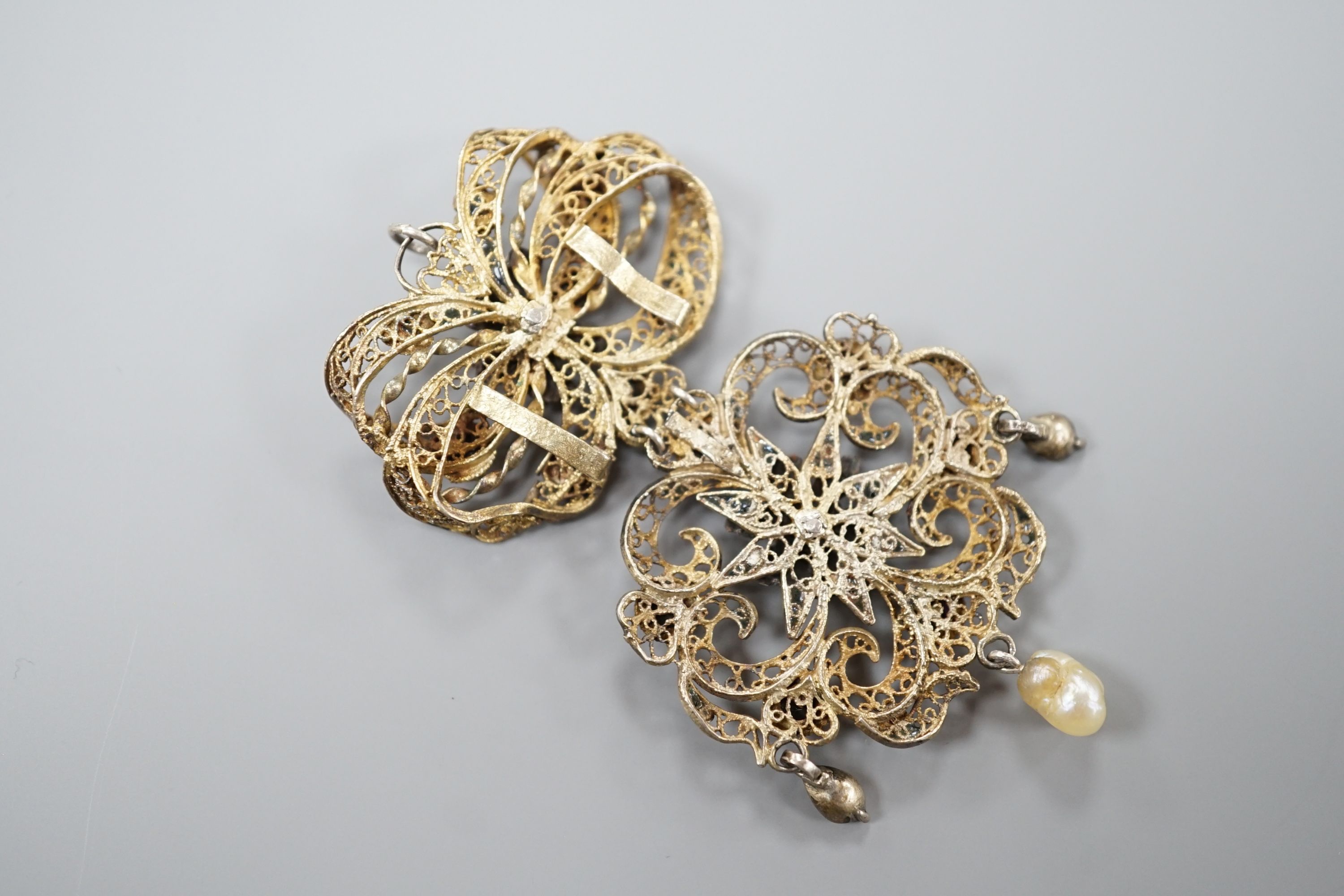 A 19th century Austro-Hungarian? gilt white metal filigree, enamel, paste and baroque pearl set drop pendant, 68mm.